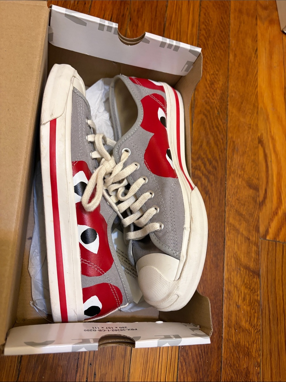Converse women’s Comme des Garçons Gray Canvas Sneakers with Red Eye Graphic
